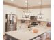 Bright kitchen features stainless steel appliances, white cabinets, and a large center island with pendant lighting at 683 Yellow Leaf Ln, Summerville, SC 29486