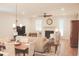 Spacious living room boasts hardwood flooring, a fireplace, and is adjacent to a dining area at 683 Yellow Leaf Ln, Summerville, SC 29486