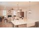 Open concept living space with an island, fireplace, hardwood flooring, and a view into the dining and living areas at 683 Yellow Leaf Ln, Summerville, SC 29486