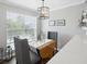Dining area with wood table, gray chairs, and natural light at 700 Daniel Ellis Dr # 10305, Charleston, SC 29412