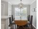 Dining area with wood table, gray chairs, and natural light at 700 Daniel Ellis Dr # 10305, Charleston, SC 29412