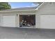 Open garage filled with storage and items, showcasing its utility and ample space at 700 Daniel Ellis Dr # 10305, Charleston, SC 29412