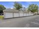 View of multiple garages with white doors in a row, providing ample parking and storage at 700 Daniel Ellis Dr # 10305, Charleston, SC 29412
