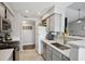 Well lit kitchen with stainless steel appliances, gray cabinets, and tile floors at 700 Daniel Ellis Dr # 10305, Charleston, SC 29412