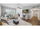 Bright living room featuring hardwood floors, contemporary furnishings, and a view of the kitchen at 700 Daniel Ellis Dr # 10305, Charleston, SC 29412