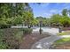 Community pool surrounded by trees, bushes and lounge chairs at 700 Daniel Ellis Dr # 10305, Charleston, SC 29412