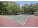 Community tennis court surrounded by trees at 700 Daniel Ellis Dr # 10305, Charleston, SC 29412