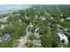 An aerial view shows a leafy neighborhood with waterfront views and tree-lined streets at 708 Pitt St, Mount Pleasant, SC 29464