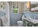 Charming bathroom with floral wallpaper, bright window, and classic fixtures at 708 Pitt St, Mount Pleasant, SC 29464
