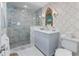 Elegant bathroom featuring a marble shower, vanity with sink, and designer wallpaper at 708 Pitt St, Mount Pleasant, SC 29464