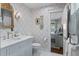 Stylish bathroom with patterned wallpaper, marble-topped vanity, and access to the bedroom at 708 Pitt St, Mount Pleasant, SC 29464