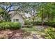 Charming cottage featuring wood siding, green shutters, and a stone pathway surrounded by lush landscaping at 708 Pitt St, Mount Pleasant, SC 29464