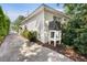 Side view of home exterior featuring white painted brick and lush landscaping at 708 Pitt St, Mount Pleasant, SC 29464