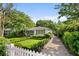 Charming home with a meticulously manicured lawn and inviting curb appeal, framed by a classic white picket fence at 708 Pitt St, Mount Pleasant, SC 29464