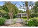 Charming home featuring a picket fence, manicured lawn, and lush landscaping, offering great curb appeal at 708 Pitt St, Mount Pleasant, SC 29464
