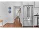 Hallway with hardwood floors, stainless steel refrigerator, and access to other rooms at 708 Pitt St, Mount Pleasant, SC 29464