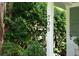 House number 708 is displayed on a pillar of the front porch, surrounded by lush foliage at 708 Pitt St, Mount Pleasant, SC 29464