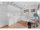 Cozy outbuilding interior with wood floors, white walls, storage, and natural light filtering through the window at 708 Pitt St, Mount Pleasant, SC 29464