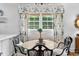 Bright kitchen nook with a table set for a meal, surrounded by natural light and stylish decor at 708 Pitt St, Mount Pleasant, SC 29464