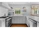 Modern kitchen featuring stainless steel appliances, white cabinetry, and ample counter space, perfect for cooking at 708 Pitt St, Mount Pleasant, SC 29464
