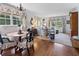 Bright living room featuring a dining table, floral curtains, comfortable seating, and hardwood floors at 708 Pitt St, Mount Pleasant, SC 29464