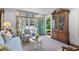 Inviting living room with stylish furnishings, a decorative wood cabinet, and view to the backyard at 708 Pitt St, Mount Pleasant, SC 29464