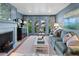 Comfortable living room featuring a fireplace, stylish furnishings, and access to the backyard at 708 Pitt St, Mount Pleasant, SC 29464