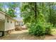 View of the home's backyard showcasing mature trees and lush greenery at 785 Coral Acres Dr, Moncks Corner, SC 29461