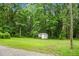 Spacious backyard featuring a small shed, greenery, and ample space at 785 Coral Acres Dr, Moncks Corner, SC 29461