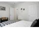 A cozy bedroom is shown with an inviting bed and a view into an adjacent room through an open door at 785 Coral Acres Dr, Moncks Corner, SC 29461
