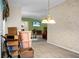 Open dining space with chandelier, neutral walls, and view to living room with boxes at 785 Coral Acres Dr, Moncks Corner, SC 29461