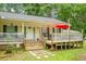 Charming home with a welcoming front porch and well-manicured lawn at 785 Coral Acres Dr, Moncks Corner, SC 29461
