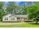 Charming single-story home featuring a cozy porch and landscaped front yard at 785 Coral Acres Dr, Moncks Corner, SC 29461
