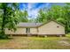 Home exterior showcasing well-maintained siding and a serene backyard setting at 785 Coral Acres Dr, Moncks Corner, SC 29461