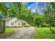 Exterior view of the home with a storage container and plenty of surrounding trees at 785 Coral Acres Dr, Moncks Corner, SC 29461