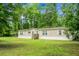 A single-story home nestled amidst a lush green lawn and mature trees on a spacious lot at 785 Coral Acres Dr, Moncks Corner, SC 29461
