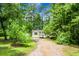 Cozy single-story home nestled among tall trees with a long driveway, offering a serene and private setting at 785 Coral Acres Dr, Moncks Corner, SC 29461