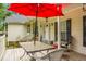 Charming front porch with outdoor seating and a red umbrella at 785 Coral Acres Dr, Moncks Corner, SC 29461