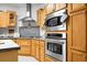 Modern kitchen features stainless steel appliances, gray backsplash, and abundant storage space at 785 Coral Acres Dr, Moncks Corner, SC 29461
