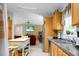 Spacious kitchen with stainless steel sink and view into living room with flat screen TV at 785 Coral Acres Dr, Moncks Corner, SC 29461