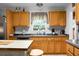 Kitchen area with light-colored cabinetry, modern sink, and window view of trees and shrubbery at 785 Coral Acres Dr, Moncks Corner, SC 29461