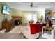 Inviting living room with fireplace, comfortable seating, ceiling fan, and hardwood style floors at 785 Coral Acres Dr, Moncks Corner, SC 29461