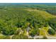 Aerial view showing a home surrounded by dense trees and natural landscapes, blending seclusion with convenience at 8453 Charleston Hwy, Walterboro, SC 29488