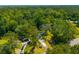 Aerial view of home and cars surrounded by dense trees on a sunny day at 8453 Charleston Hwy, Walterboro, SC 29488
