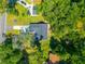 Aerial view of a gray house with a dark gray roof surrounded by mature trees at 8453 Charleston Hwy, Walterboro, SC 29488