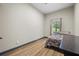 Bedroom with wood flooring and neutral colored walls, well-lit from the natural light streaming through the window at 8453 Charleston Hwy, Walterboro, SC 29488