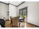 Cozy dining area with a round table, upholstered chairs, and a view of the outdoors through the double glass doors at 8453 Charleston Hwy, Walterboro, SC 29488