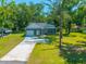 Charming single-story home with a lush green lawn and a long driveway leading to an attached garage at 8453 Charleston Hwy, Walterboro, SC 29488