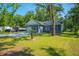Welcoming home exterior featuring well-kept landscaping, covered parking, and a concrete driveway at 8453 Charleston Hwy, Walterboro, SC 29488