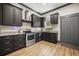 Modern kitchen with sleek black cabinets, stainless steel appliances, granite countertops, and a stylish backsplash at 8453 Charleston Hwy, Walterboro, SC 29488